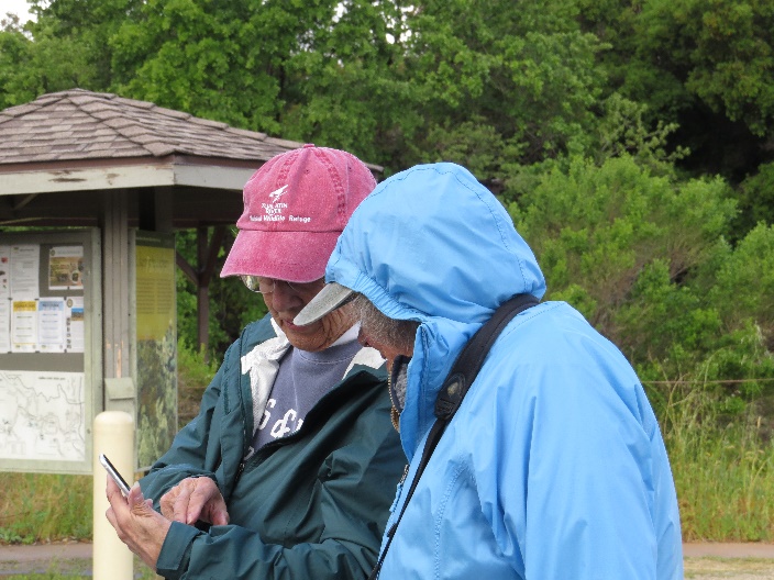 A couple of men looking at a cellphone

Description automatically generated with low confidence